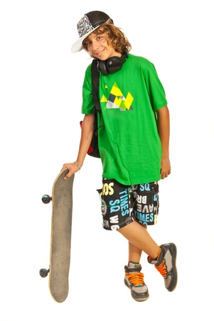Cheerful schoolboy teen boy with skateboard isolated on white backgroundの写真素材