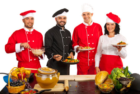Group of chef team showing food and smiling isolated on white 