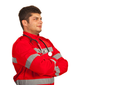 Paramedic man looking away to copy space and standing with arms folded isolated on white backgroundの写真素材