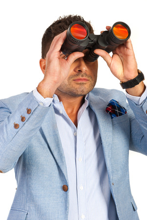Business man with binocular isolated on white backgroundの写真素材