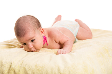 Laying newborn baby two months age having neck Kinesiology Tape for congenital torticollisの写真素材