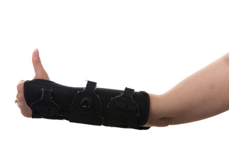 Close  up of woman hand in  orthosis isolated on white background