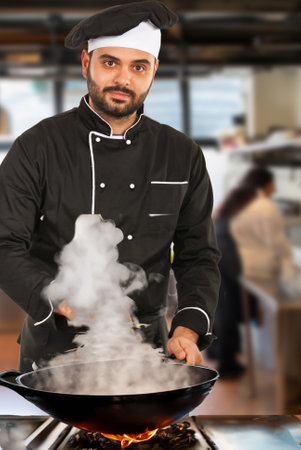 Chef man ready to put soup on a plate in kitchenの写真素材