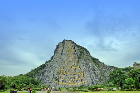 Touristic place in Thailand, Golden Buddha.Giant picture made of gold on the rock.の写真素材