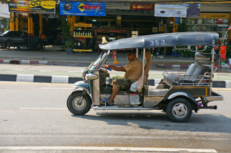 CHIANGMAITHAILANDAPRIL 142011:Unidentified taxi driver with traditional tuktuk in a water fight festival or Songkran Festival Thai New Year on April 14 2011 in Chiangmai Thailand.のeditorial素材