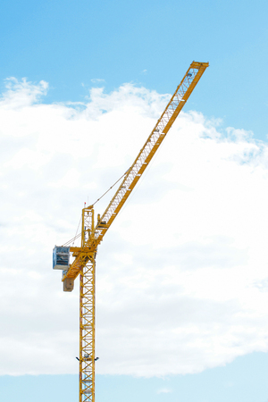 Yellow Industrial crane and blue sky on construction site or seaportの写真素材
