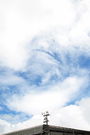 Antennas of mobile cellular systems with wifi hot spot repeater and blue skyの写真素材