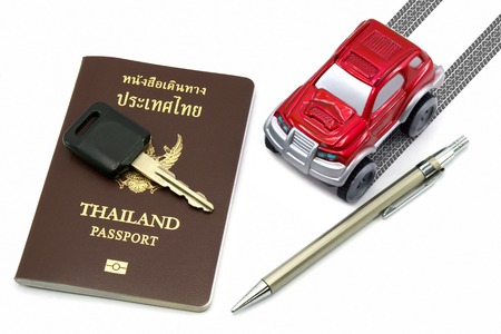 Thailand passport, key, pen and red 4wd car for travel concept.の写真素材