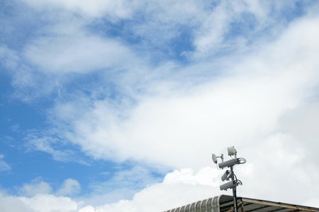 Antennas of mobile cellular systems with wifi hot spot repeater and blue skyの写真素材