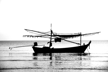 The silhouette of fishing boatの写真素材