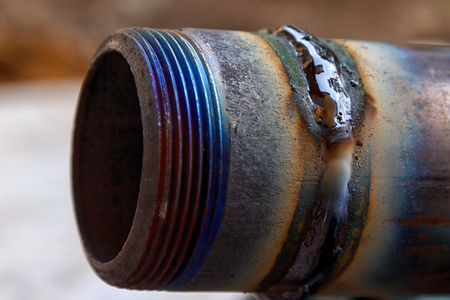 fresh weld bead on a metal tube macroの写真素材