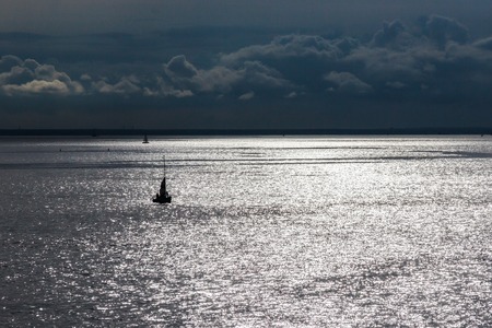 a lonely boat, calm, waters of the Neva river, evening walkの写真素材