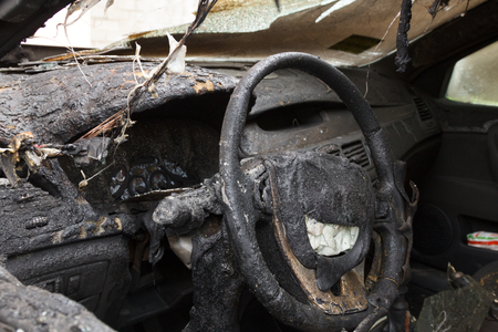 partially burned down parts of the car, the children's chair, meter panel, airbag, chair upholstery, the radio tape recorder, charred the panel and which has burst from temperature car glassの写真素材