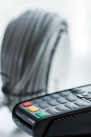 card payment terminal, on background the wires