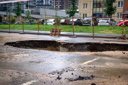 Saint Petersburg, Russia - June 2019: hole in the road, the asphalt collapsed, because of the groundwater. under repair.のeditorial素材