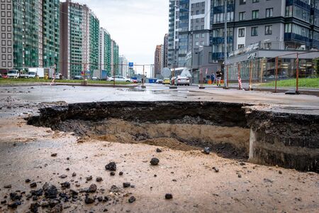 Saint Petersburg, Russia - June 2019: hole in the road, the asphalt collapsed, because of the groundwater. under repair.のeditorial素材