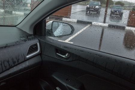 rain in the car, raindrops fly through the open window,