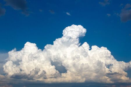cumulus and high-cumulus clouds of an average tier on blue heavenly space.の写真素材