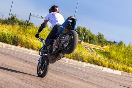 St. Petersburg, Russia - June 2019: moto rider making doing a difficult and dangerous stunt on his motorbikeのeditorial素材