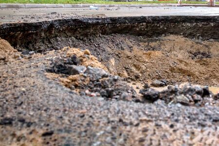 Saint Petersburg, Russia - June 2019: hole in the road, the asphalt collapsed, because of the groundwater. under repair.のeditorial素材
