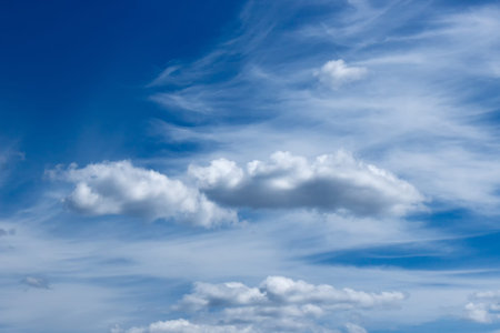 plumose clouds of the top tier in blue space of the sky.