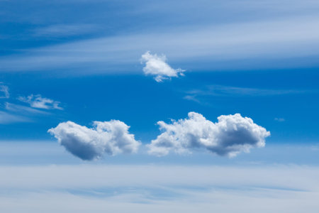 plumose clouds of the top tier in blue space of the sky