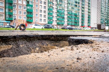 Saint Petersburg, Russia - June 2019: hole in the road, the asphalt collapsed, because of the groundwater. under repairのeditorial素材