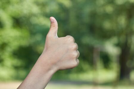 picnic thumb up hand sign baby hand showing thumb up, like ok positive hand gesture.の写真素材
