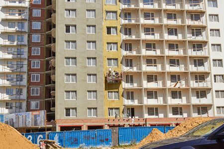 St. Petersburg, Russia-July 28, 2019: Facade thermal insulation works with stopping.のeditorial素材