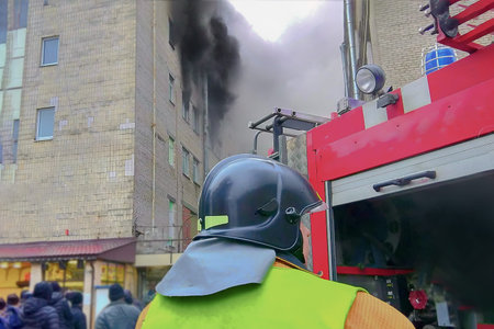 firefighter in front of a fire in a high-rise trade building, fighting fires in a big city.