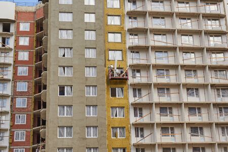 St. Petersburg, Russia-July 28, 2019: Facade thermal insulation works with stopping.のeditorial素材