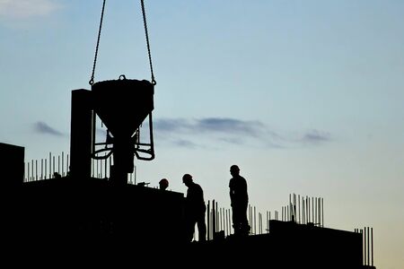 Industrial construction cranes the construction of an building.の写真素材