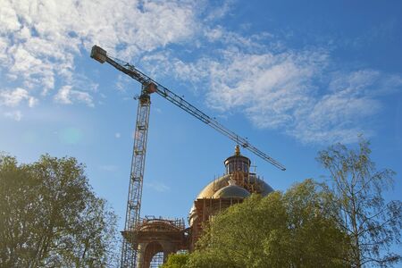 Industrial construction cranes the construction of an building.の写真素材