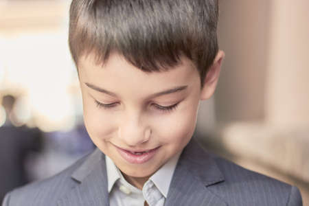 back to school portrait of a young boy with a backpack and a business suit.の写真素材