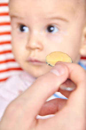 spoon with porridge for a child, the concept of feeding a child through the eyes of an adult.の写真素材