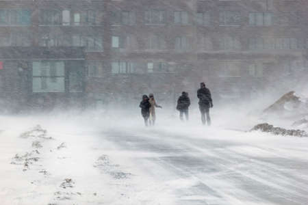 Blizzard bad weather snow and strong wind in the city.の写真素材