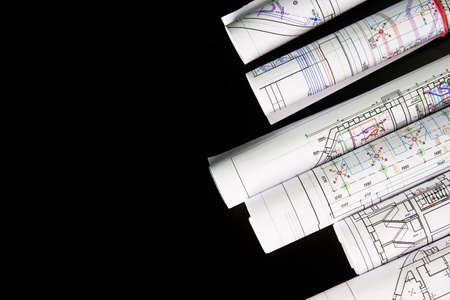 Architectural project, drawings on a dark background. Rolls of project drawings.の写真素材