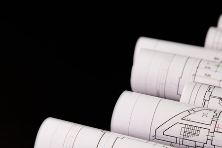 Architectural project, drawings on a dark background. Rolls of project drawings.