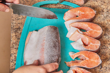 Cutting red fish into pieces to prepare the dishの写真素材