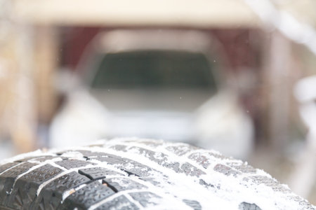 Tires on the background of a car in the garage, the concept of replacing rubber
