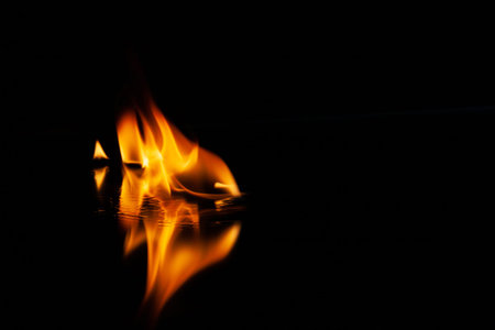 fire flame with reflection in the glass on a black background selective focus.
