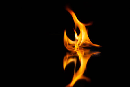 fire flame with reflection in the glass on a black background