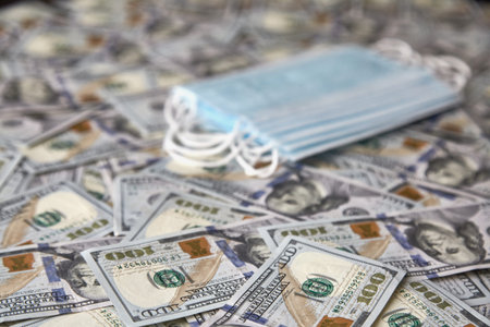 medical mask on the background of dollars