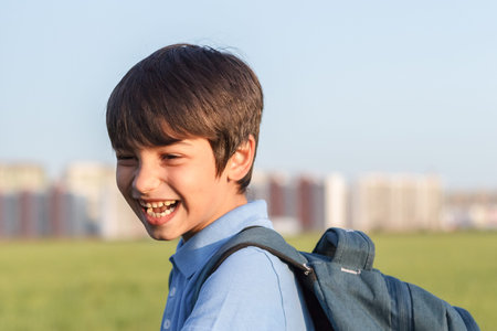 Returning to school concept, portrait of happy boy with backpack, school child waiting for school...