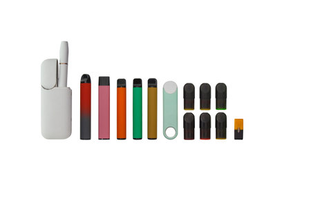 Pictured disposable e-cigarettes in assortment, isolated on white background top view