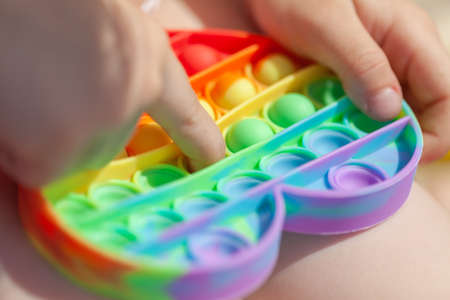Baby fingers and antistress toy simple dimpleの写真素材