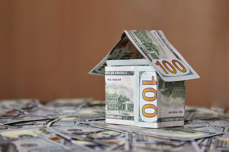 house of money on the background of money, dollar bills the concept of accumulating investing money