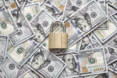 Financial security. padlock on the background of money. The concept of storing and protecting saving moneyの写真素材
