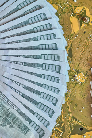 Circuit board chips, electronics, against the background of money. The concept of technological...