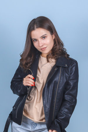 Cute young brunette in a black leather jacket